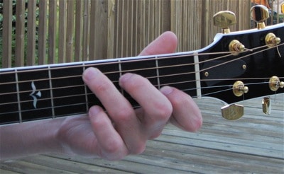 Place your fingers directly behind the correct frets to avoid string buzz.